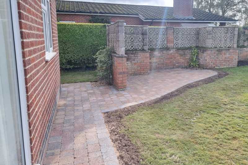 Landscaping works in Budbrooke, Warwick. Driveway, pathways and patio block paving works complete. Tumbled block paving laid for pathway and patio works.