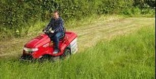 Ride on mower in field