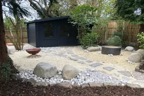 Landscape garden build complete with paving, boulders, fire bowl, water feature and contemporary garden studio outbuilding.