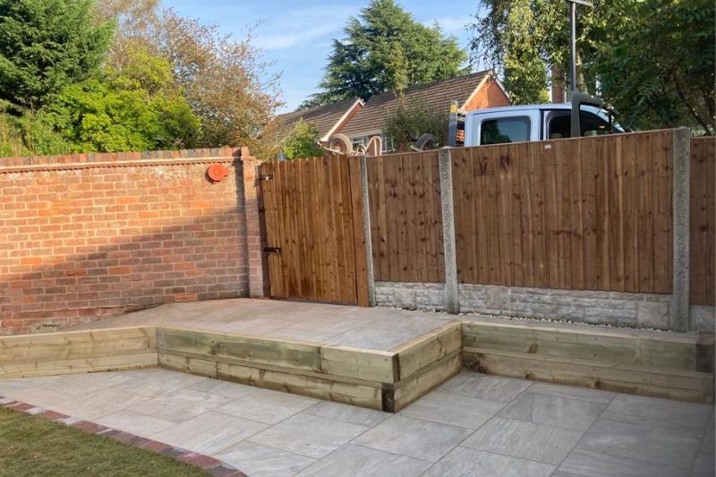 Landscaping works in Solihull. Raised patio area completed works in garden. New fencing and gate installed.