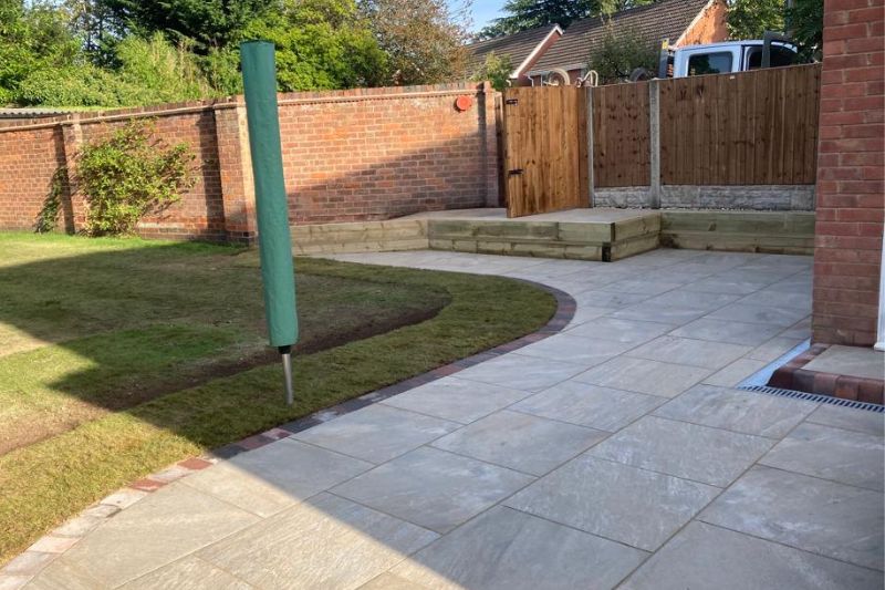 Landscaping works completed in Solihull. Raised patio and porcelain patio with block edging. New fencing and gate installed.