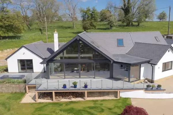 Large detached contemporary luxurious property in rural countryside setting with raised deck terrace installed using the iGarden light steel subframe foundation system.