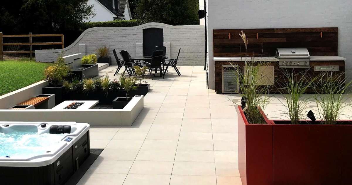 iGarden Vision, Contemporary Outdoor Living, porcelain patio, grp planters, 12v garden lighting, hot tub and sunken firepit seating area.