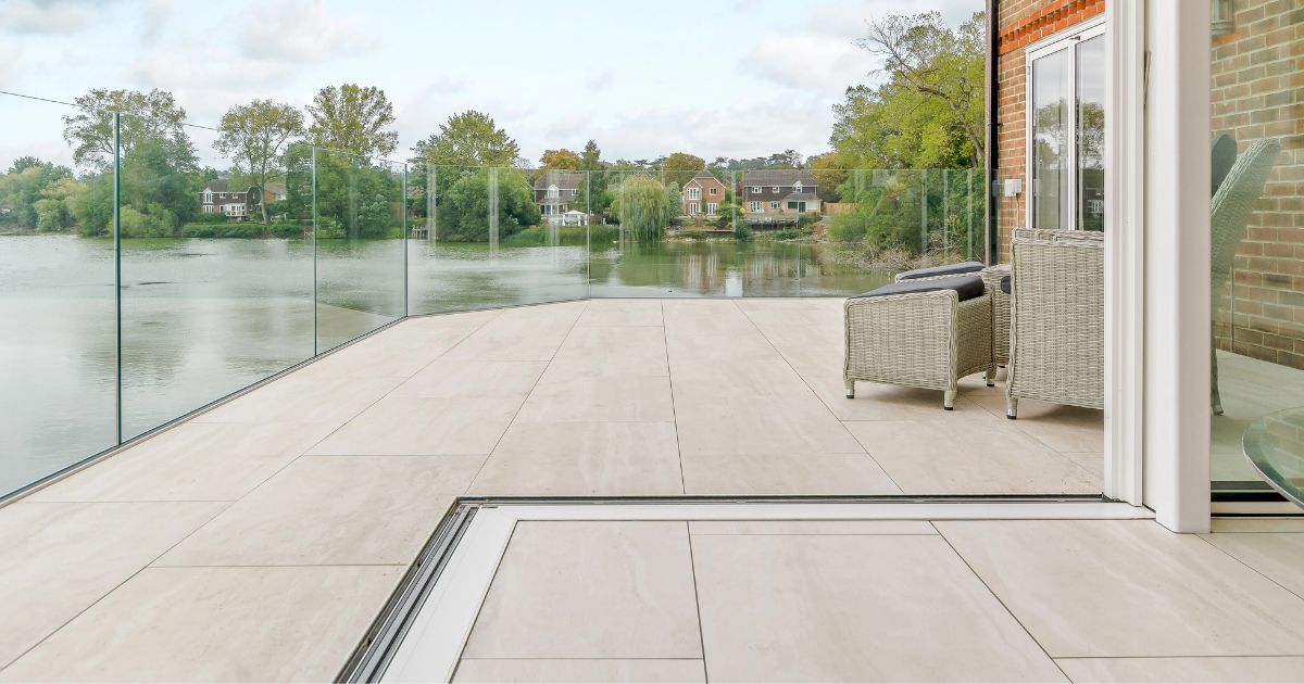 iGarden Vision, modular paving subframe system installed to create porcelain patio terrace level with threshold around rear home extension with stunning lakeside views.