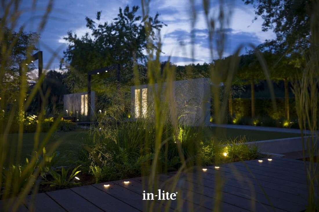 Contemporary design garden illuminated paths, borders, plants and trees with integrated low voltage outdoor LED lighting by in-lite.