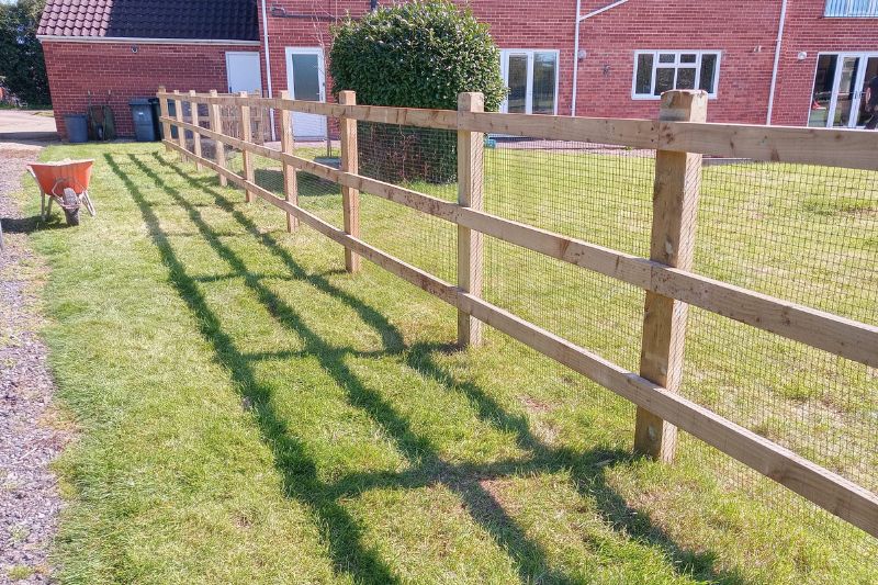 Fencing works. Garden picket fence gates installed and post and rail fencing built along garden to create sections.