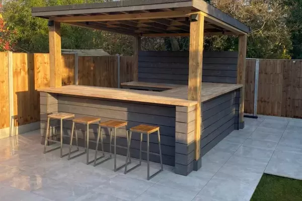 Garden outdoor kitchen diner building integrated in light steel sub frame fitted base foundation and surrounding patio finished with outdoor porcelain tiles.