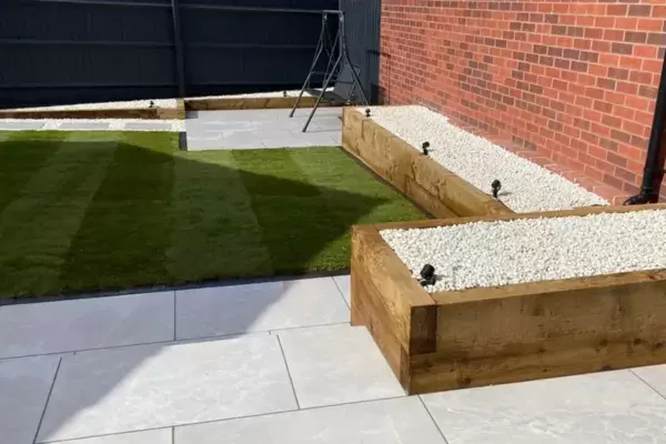 Garden transformation landscaping works complete with raised planting beds built of timber sleepers and lighting.