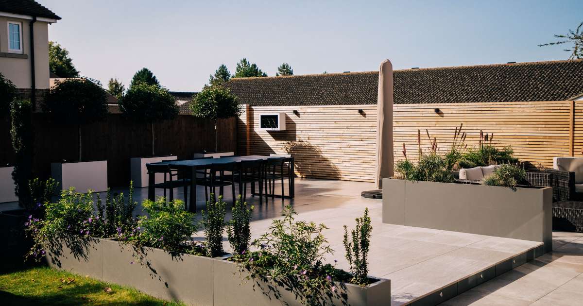 iGarden Vision, Contemporary Outdoor Living, porcelain patio, grp planters, slatted fencing and 12v garden lighting.