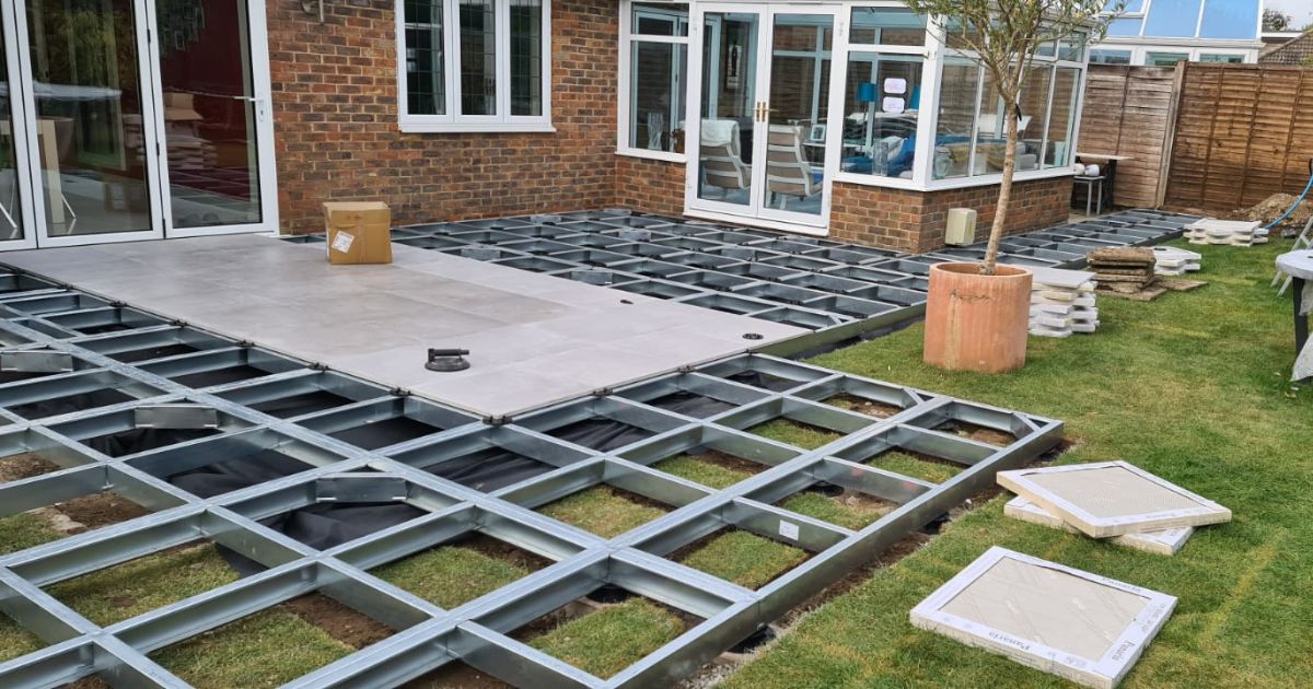 iGarden Vision, modular paving subframe system installed to create a porcelain patio level with threshold around rear house exterior.
