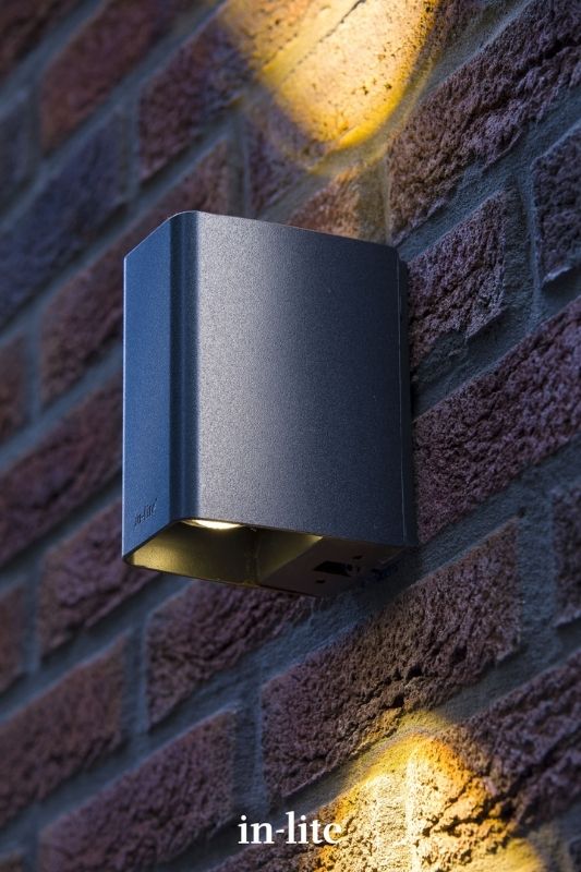 in-lite ACE UP DOWN DARK 12v outdoor wall light illuminating exterior wall with a direct beam of light upwards and downwards. Low voltage outdoor garden lights, atmospheric lighting for ambiance.