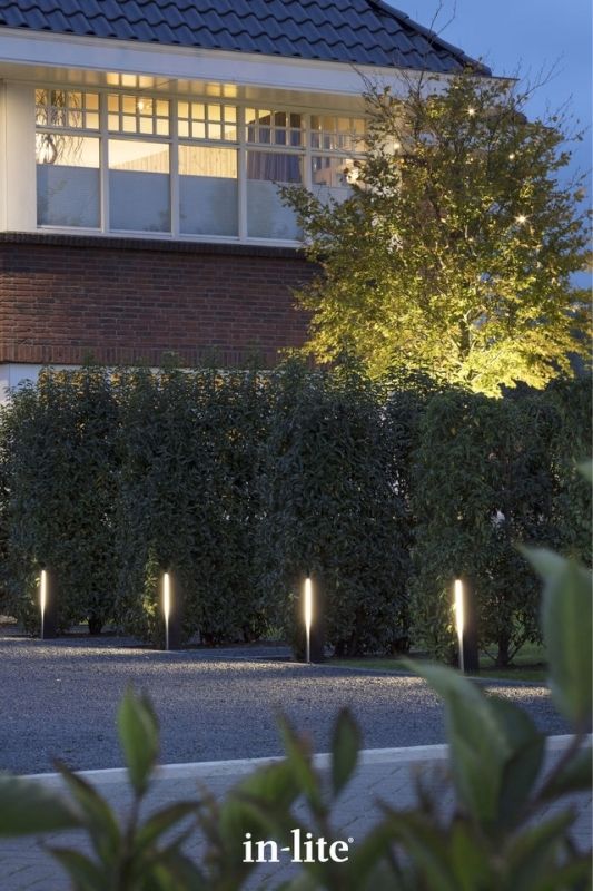 in-lite EVO DARK 12v outdoor bollard lights, positioned upright along driveway border, illuminating along the border with a considerable amount of light without glare. Low voltage outdoor garden lights, atmospheric lighting for ambiance.