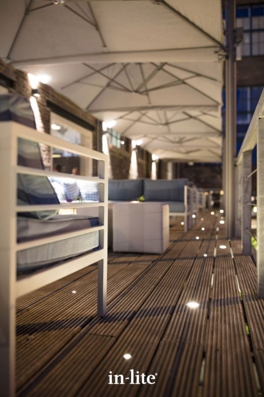 in-lite FUSION and FUSION 22 RVS 12v outdoor decking lights, installed in decking boards, illuminating with a soft ambient glow to provide an indicative pattern along the walkway. Low voltage outdoor garden lights, atmospheric lighting for ambiance.