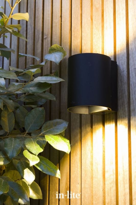 in-lite HALO UP DOWN 12v outdoor wall light, illuminating exterior wall of outdoor garden building, with a wide warm white light beam up and down. Low voltage outdoor garden lights, atmospheric lighting for ambiance.
