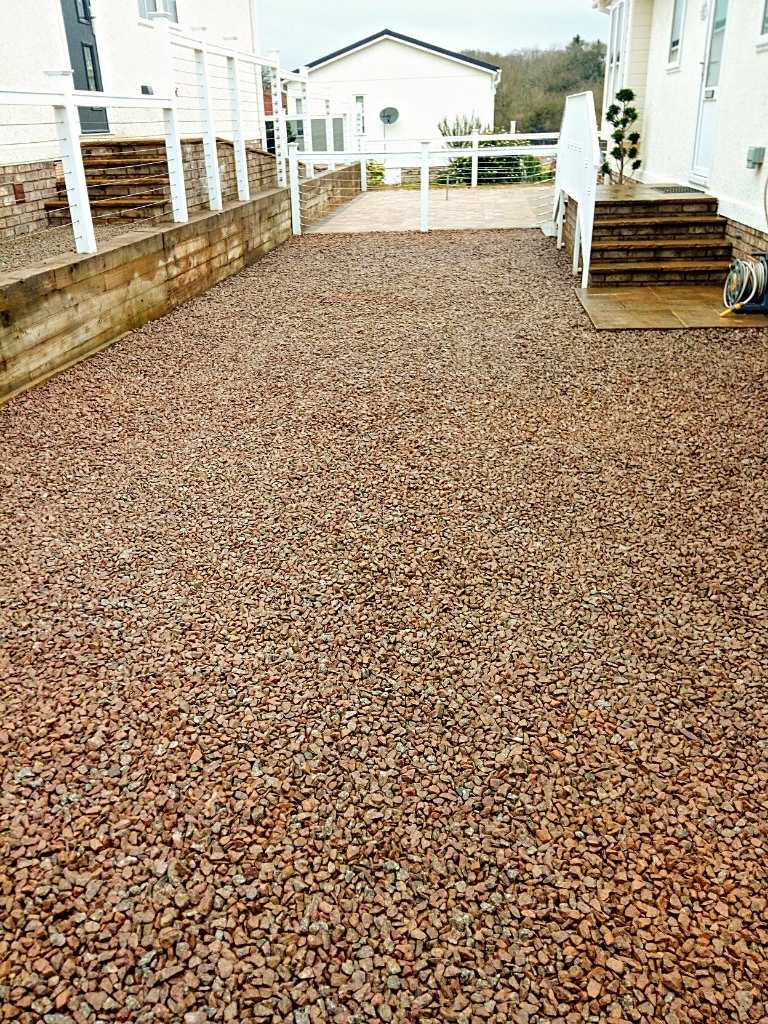 Domestic landscape garden transformation with decorative gravel driveway and decorative paving installation works at Broadwell Woods Residential Park in Burton Green, Kenilworth - Oakland Group.