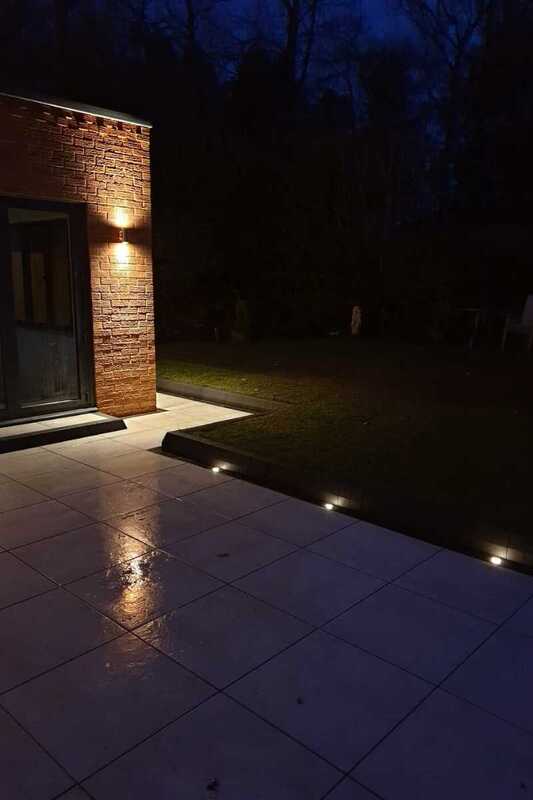 240v Up-Down Wall light fitting complemented by safe 12 volt outdoor recessed lights in porcelain patio outdoor space.