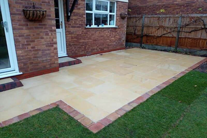 Ethan Mason Smooth Dune Natural Stone Paving with block edge in rear garden landscape transformation patio installation works in Solihull - Oakland Group