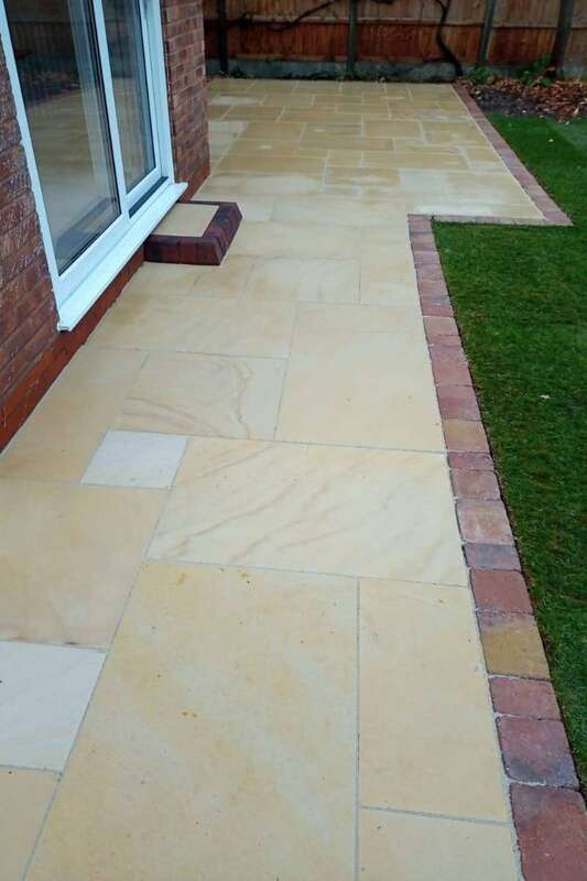 Ethan Mason Smooth Dune Natural Stone Paving with block edge and patio step in rear garden landscape transformation patio installation works in Solihull - Oakland Group