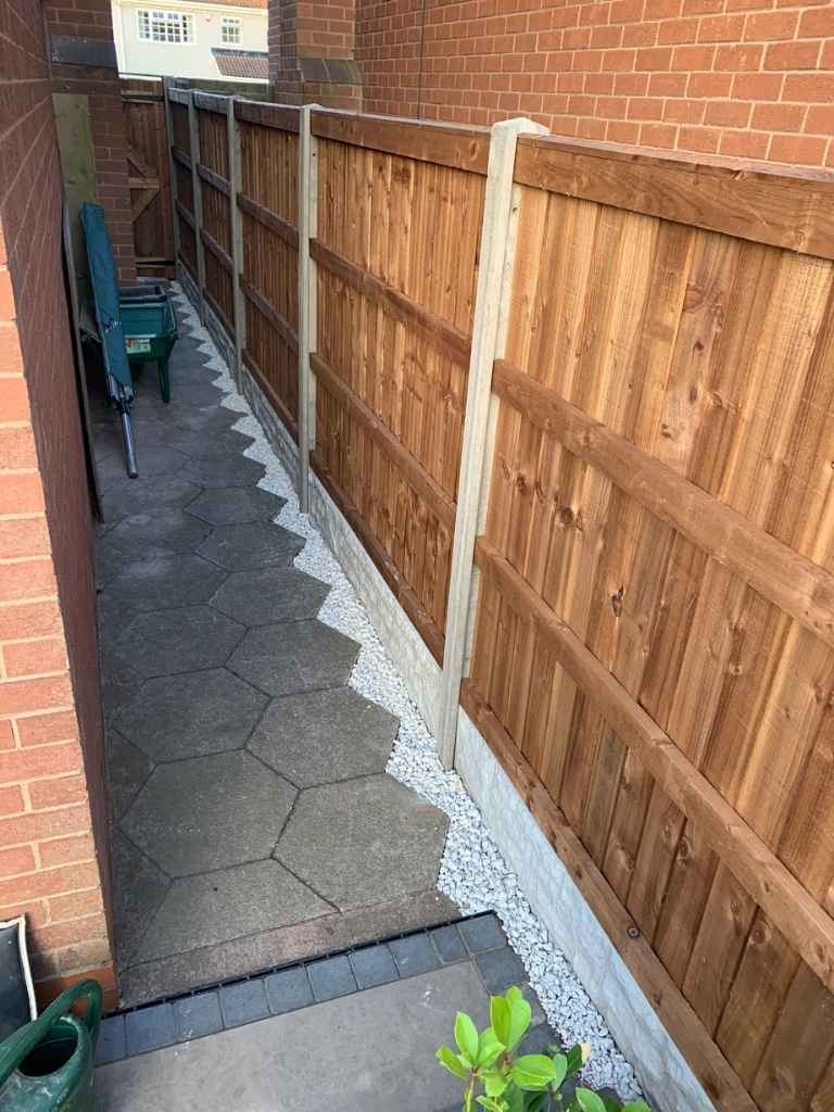New garden gate, fencing complete with decorative gravel, supplied and fitted by landscape installation team in Damson Parkway, Solihull - Oakland Group.