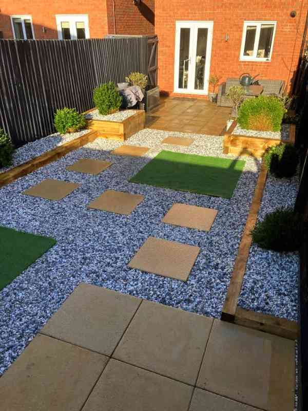 New garden makeover with raised sleeper planting beds, decorative gravel, artificial lawn and paving flags leading to a new patio space in Hall Green, Birmingham - Oakland Group Landscaping Services.