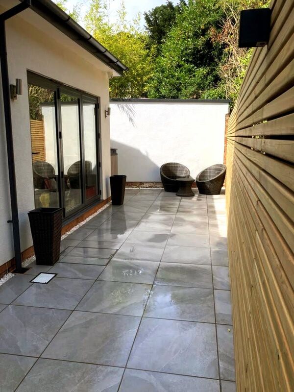Landscaping works completed in Dorridge Solihull. Porcelain patio and pathway built for new contemporary home rear extension. Slatted fencing and low voltage outdoor lighting installed.
