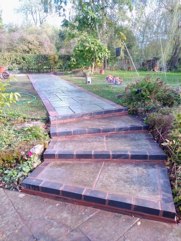 Landscaping works completed in Nether Whitacre Birmingham. New natural stone pathway and pergola installed in garden.