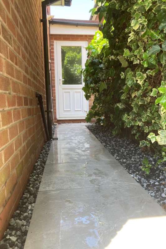 Landscaping works in Dorridge, Solihull. New porcelain patio with side pathway completed. Prima porcelain outdoor tiles. Main patio and pathways consist of 2cm Marble Light Grey 60 x 90cm. Decorative gravel border installed on each side of the porcelain paths.