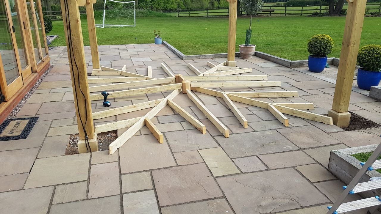 Landscaping works in progress in Rowington Warwick. Gazebo roof assembled ready to be raised in place.