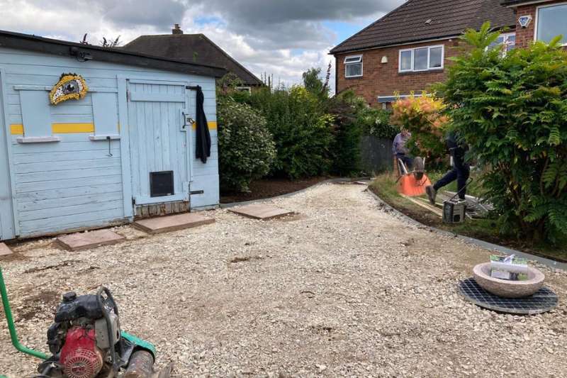 Landscaping works in progress in Solihull. Ground preparation for decorative gravel and stone water feature in garden transformation works.