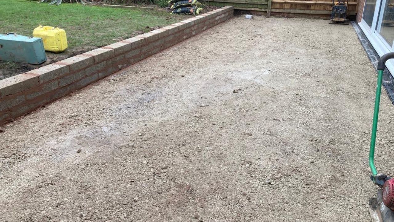 Landscaping works in progress in Solihull. Concrete block retaining wall built. Compressed hardcore foundation laid in preparation for new patio works.