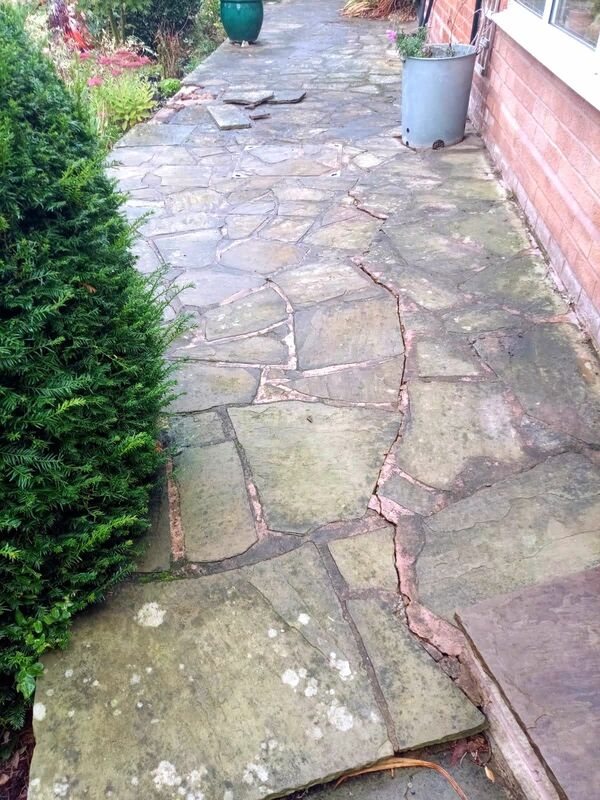 Landscape garden before landscaping works in Solihull. Old craving paving with long crack along paving.