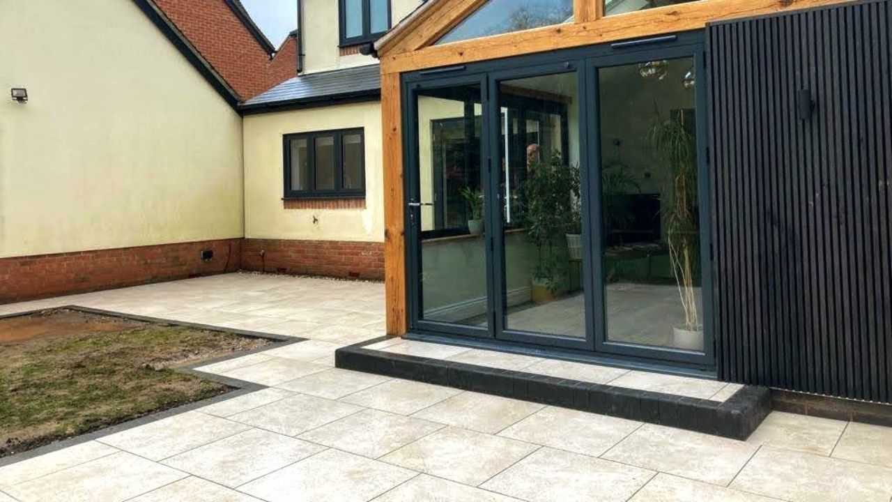 Landscaping works completed in Stratford upon Avon. Wrap around porcelain patio built for new contemporary home rear extension with bi-fold doors.