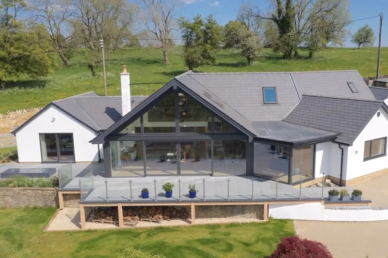 Large detached contemporary luxurious property in countryside setting with raised deck terrace installed using the iGarden light steel subframe foundation system.