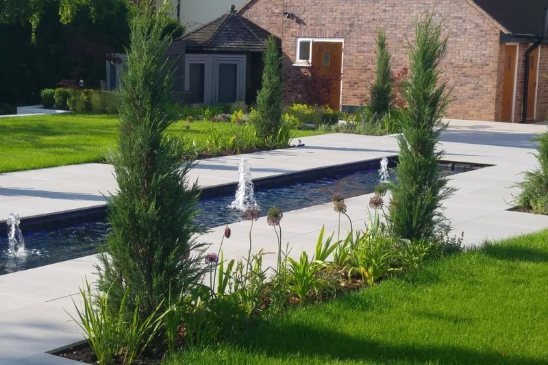 Large countrside landscape garden transformation project complete with outdoor porcelain walkways and water fountains installed using the iGarden light steel subframe foundation system.