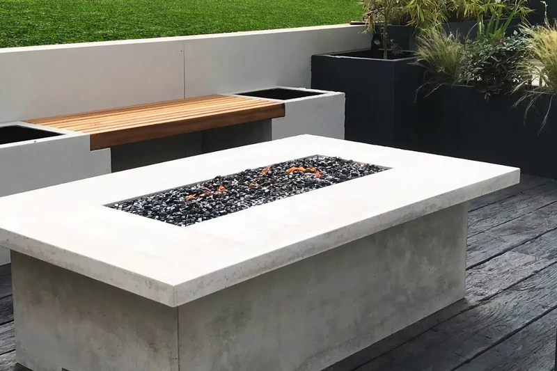Large terrace sunken patio space with iroko bench seating and fire place installed using the iGarden light steel subframe foundation system.