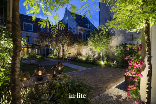 in-lite SCOPE Outdoor Spotlights illuminating trees and plants in a mature garden.