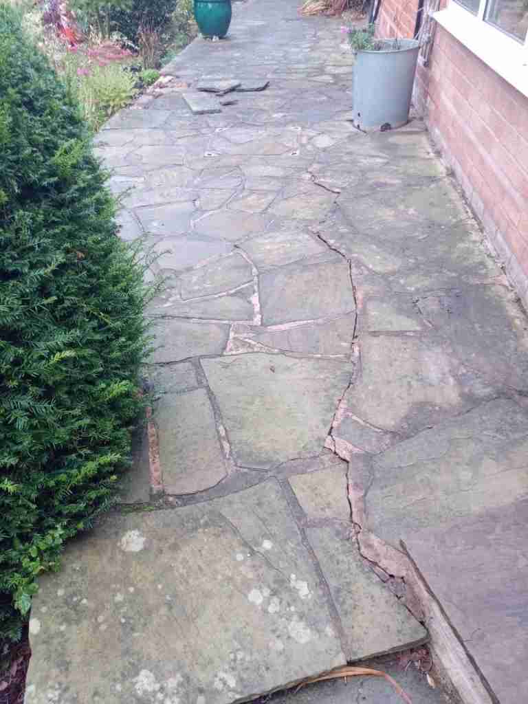 Old garden paving with mortar cracks before patio works in Solihull - Oakland Group.