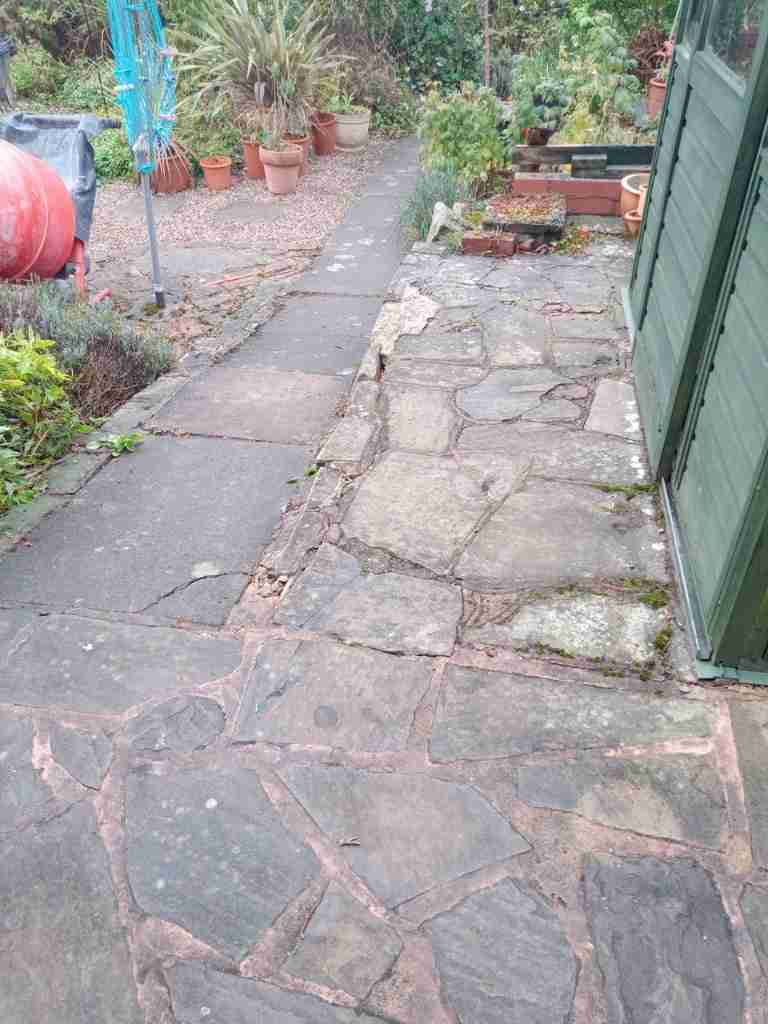 Old garden paving sloping pathway with unstable foundations in Solihull - Oakland Group.
