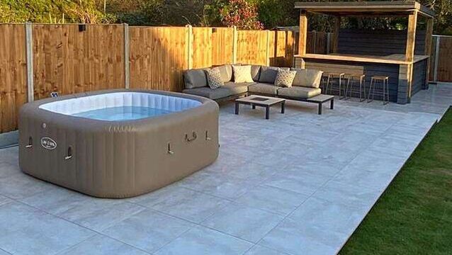 iGarden porcelain patio with custom made bar-diner, hot tub and garden furniture seating.