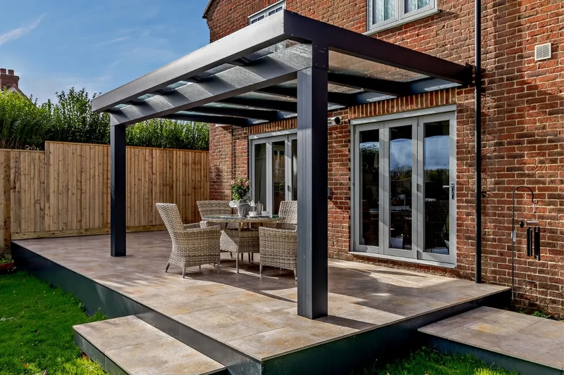 Raised terrace patio with outdoor porcelain, steps and Sunspaces Veranda installed using the iGarden light steel subframe foundation system.