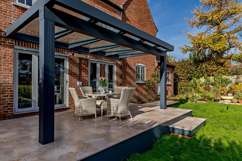 Raised terrace patio with outdoor porcelain, steps and a Sunspaces veranda installed on the iGarden light steel subframe foundation system.