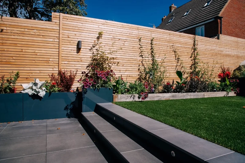 Low maintenance contemporary garden on split levels with outdoor porcelain steps and patio installed using the iGarden light steel subframe foundation system.